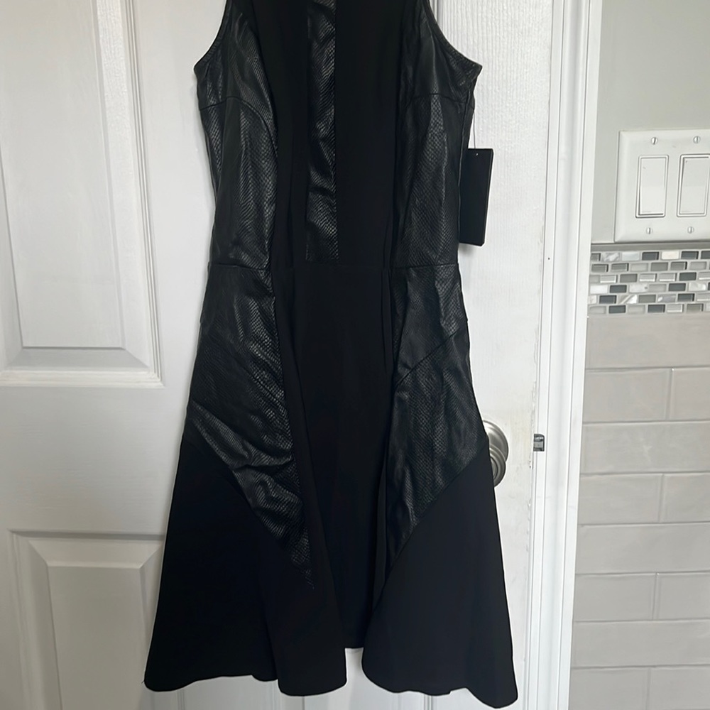 Very cute spandex - polyester - faux leather look black fitted and slight flare